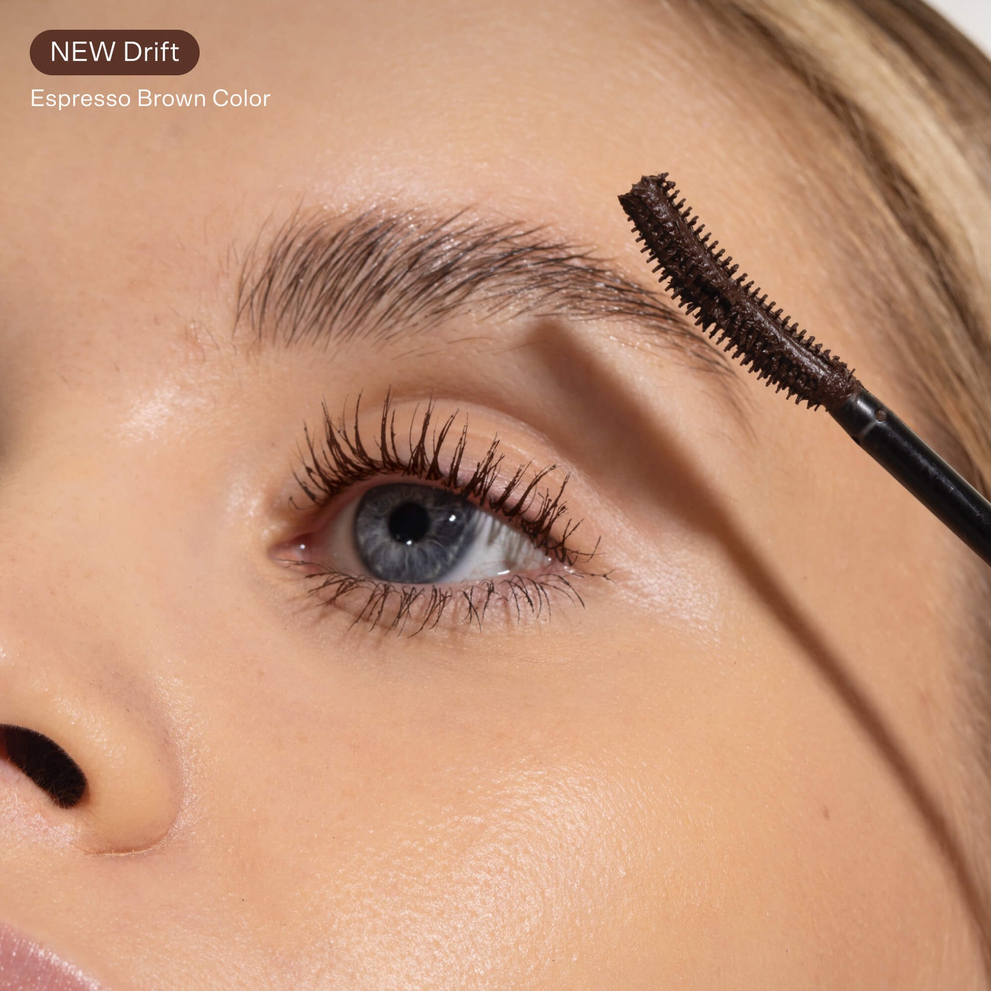 A model demonstrating the effects of the Tower 28 Beauty MakeWaves™ Mascara in Drift on light, sparse, and thin lashes
