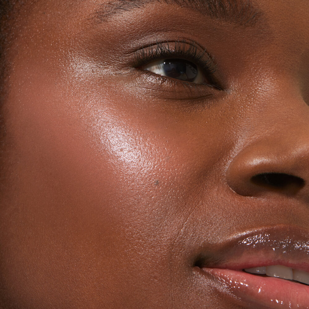 A close up of a model with Tower 28 Beauty's BeachPlease Cream Blush in Magic Hour on her face.