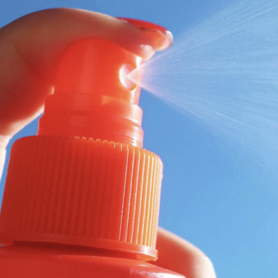 [A close up of the Tower 28 Beauty SOS Rescue Spray being spritzed out of the bottle's nozzle.]