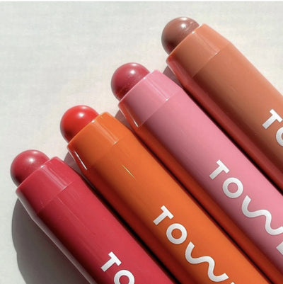 [A close up of all four shades of the Tower 28 Beauty JuiceBalm Lip Balm.]