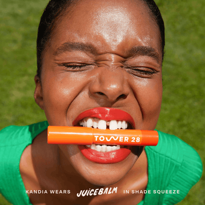 Shade: Squeeze [Shared: A close up of a model wearing Tower 28 Beauty's JuiceBalm Lip Balm in the shade Squeeze]