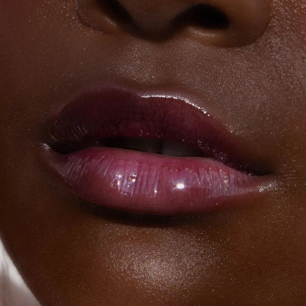 A model wearing the Tower 28 Beauty ShineOn Lip Jelly in the shade Fear Less on her lips