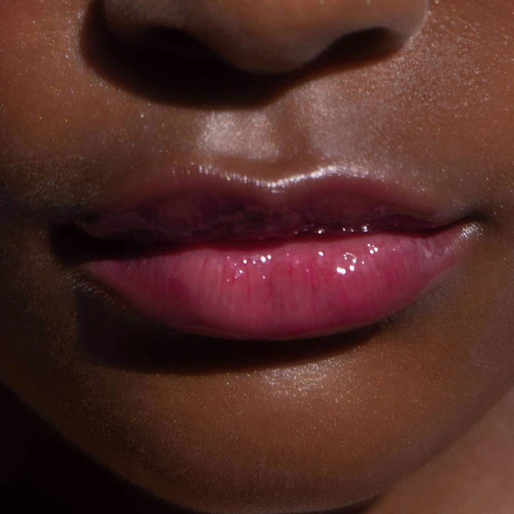 A model wearing the Tower 28 Beauty ShineOn Lip Jelly in the shade XOXO on her lips