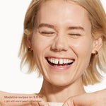 Woman with a bright smile, showcasing teeth, on a white background. [3.0 CC]