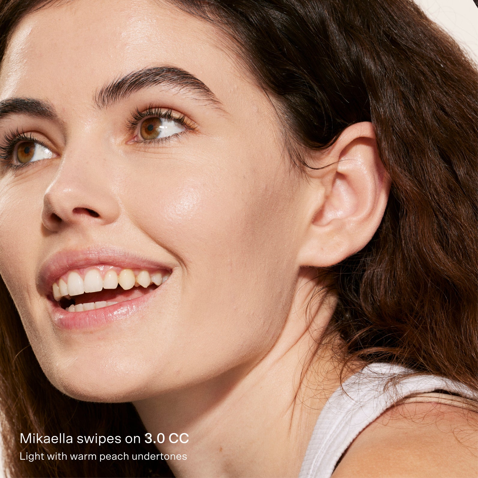 Close-up of a woman's face with a focus on her skin texture, wearing a light-colored top. [3.0 CC]