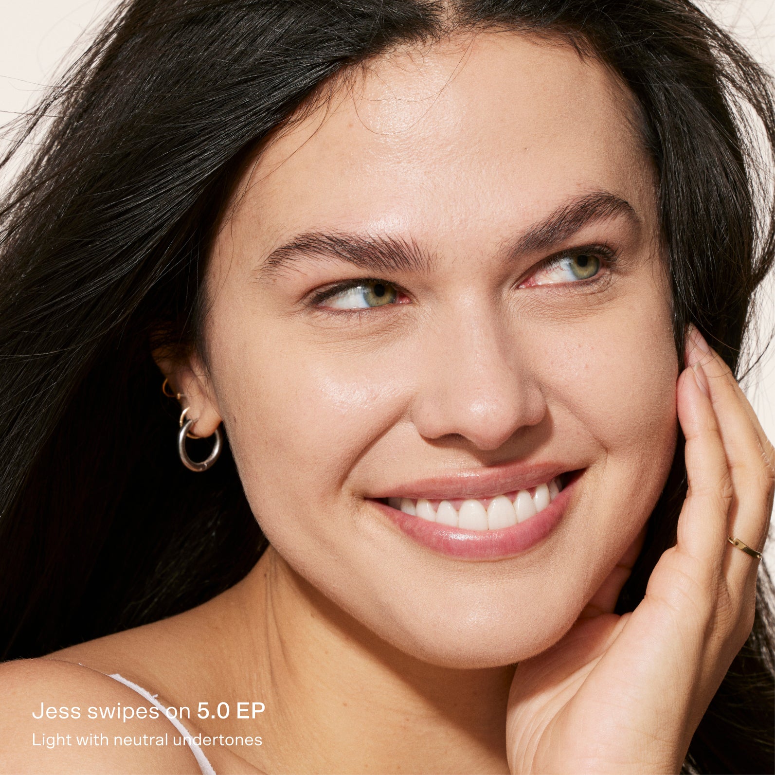 Close-up of a woman with a soft smile, wearing minimal makeup. [5.0 EP]