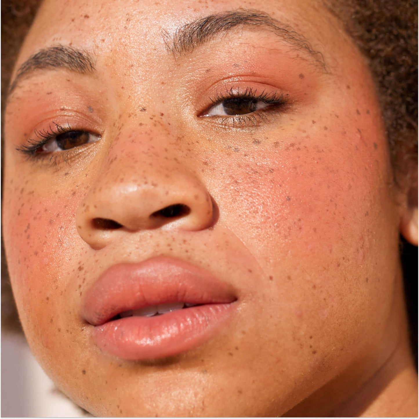 Rush Hour [A close up of a model with Tower 28 Beauty's BeachPlease Cream Blush in Rush Hour on her face.]