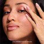 [Close-up of a woman applying makeup featuring the text 'Jada Wears GoGo in Avalon']