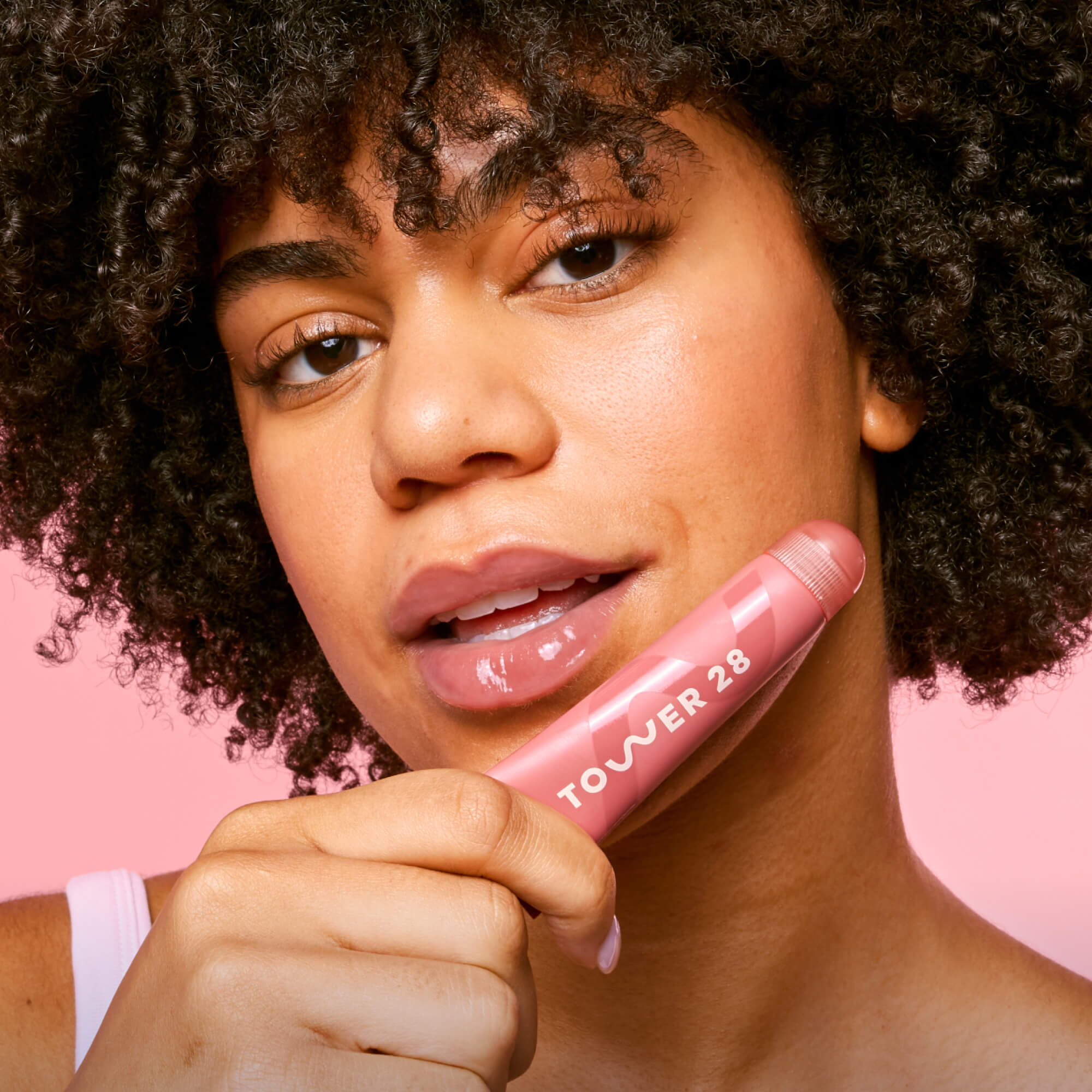 Tower 28 Beauty's LipSoftie® Lip Treatment in Red Bean Mochi applied on model. [Red Bean Mochi]
