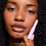 Close-up of a woman applying makeup [Roxy]