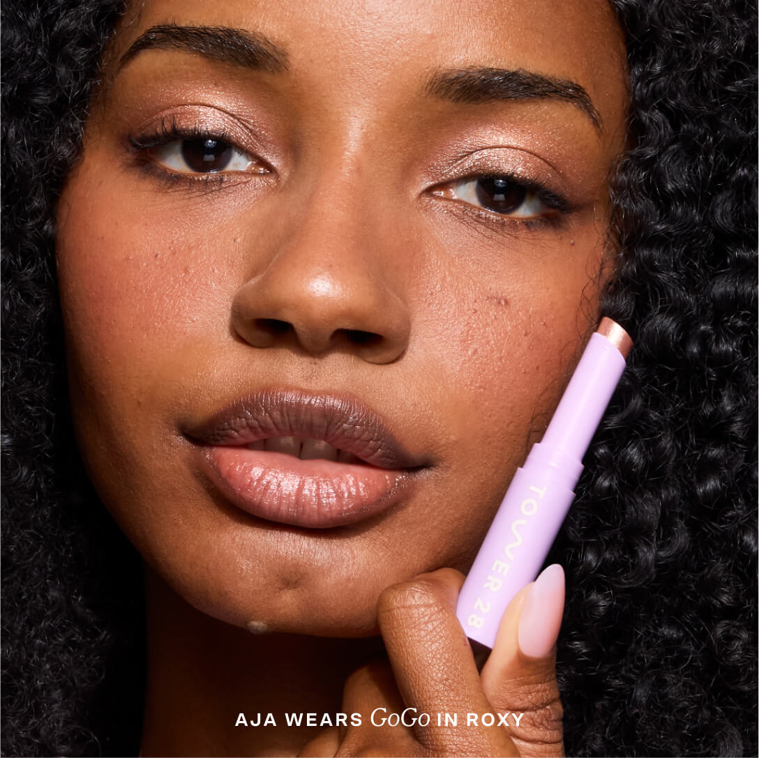Close-up of a woman applying makeup [Roxy]