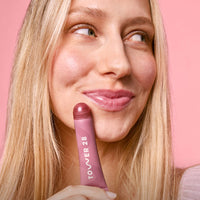 Tower 28 Beauty's LipSoftie® Lip Treatment in Sugar Plum applied on model. [Sugar Plum]