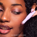 Close-up of a woman applying makeup [Viper]