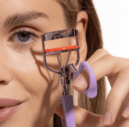 [Shared: A model holding Tower 28 Beauty's MakeWaves Lash Curler showing her curled and lifted lashes after use.]