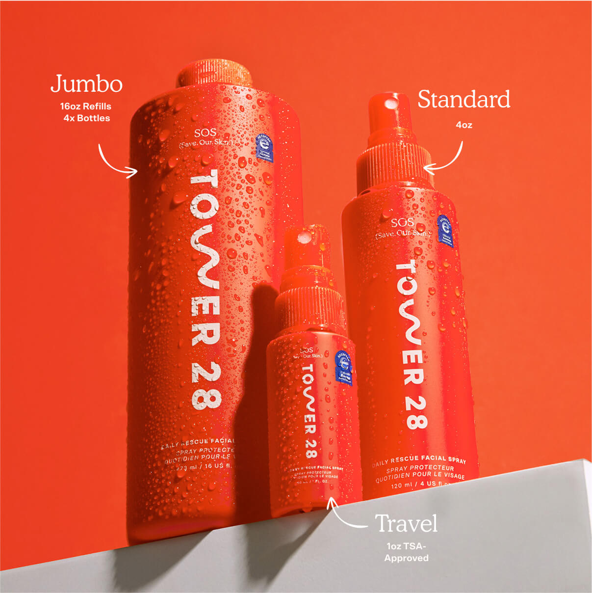 Three sizes of Tower 28 bottles on an orange background [Shared]