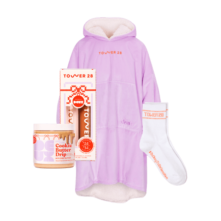[Shared: Tower 28 Beauty's Holiday Drip Gift Box which includes a light purple Comfy®, a pair of white crew socks with orange details, Deux Cookie Butter Drip, and Lip Drip Duo.]