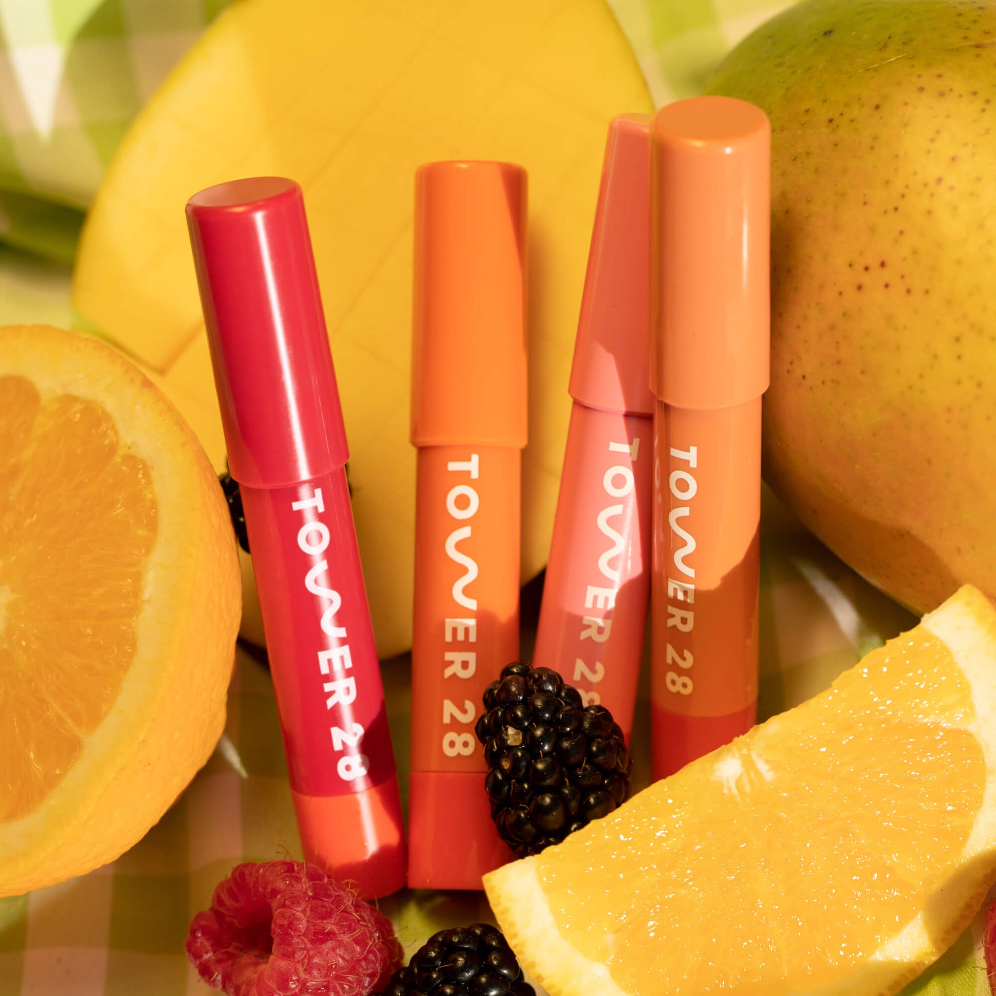 Shared: A close up of all four shades of Tower 28 Beauty's JuiceBalm: Drink, Shake, Mix, and Squeeze).