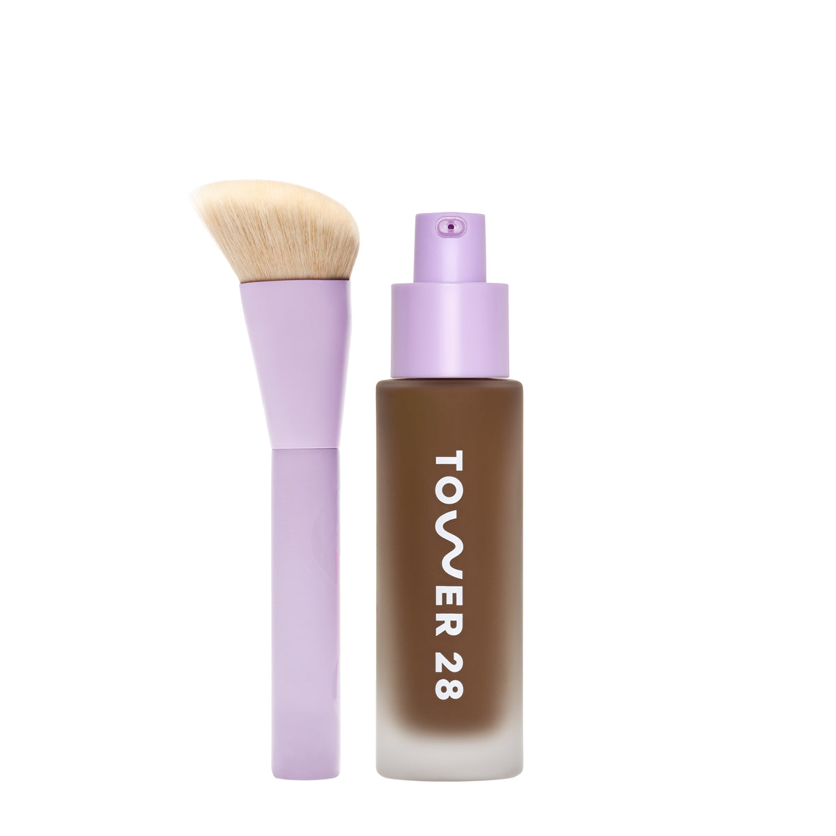 [shared] Tower 28 liquid foundation bottle in a frosted brown glass with a lavender pump, shown next to a matching lavender makeup brush with beige bristles on a white background.