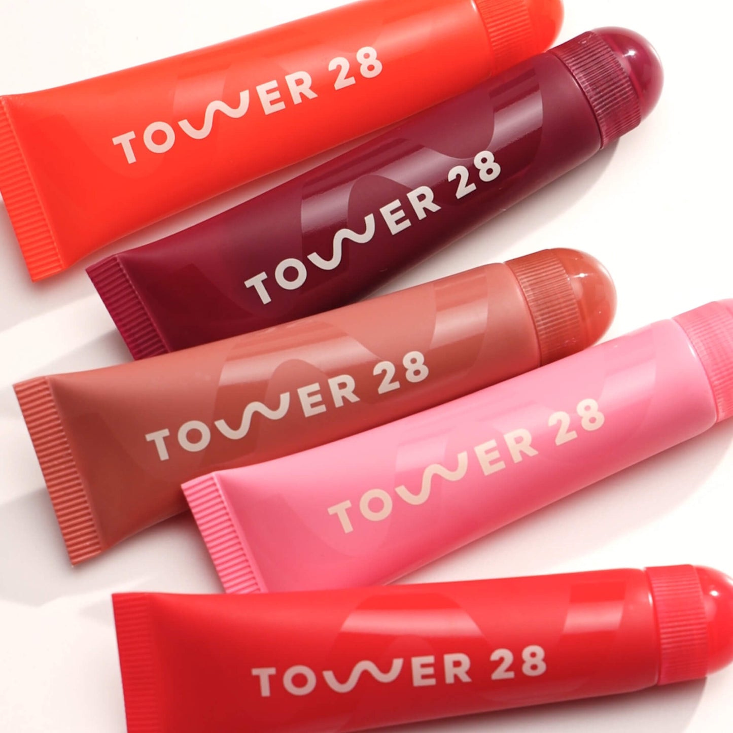 [Family group photo of the Tower 28 Beauty LipSoftie™ Lip Treatment on white]