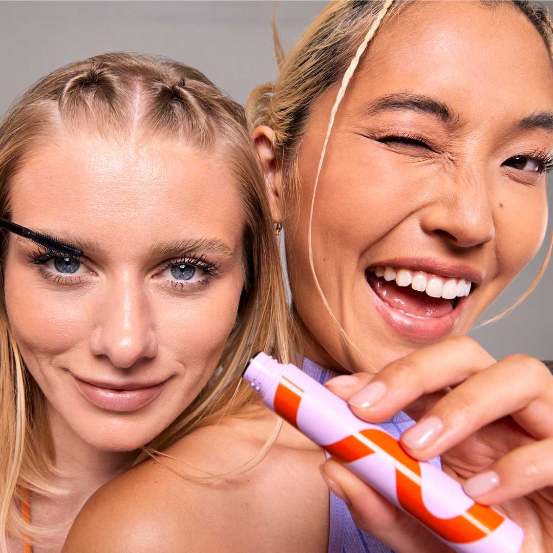 [Two models wearing the Tower 28 Beauty MakeWaves™ Mascara in Jet