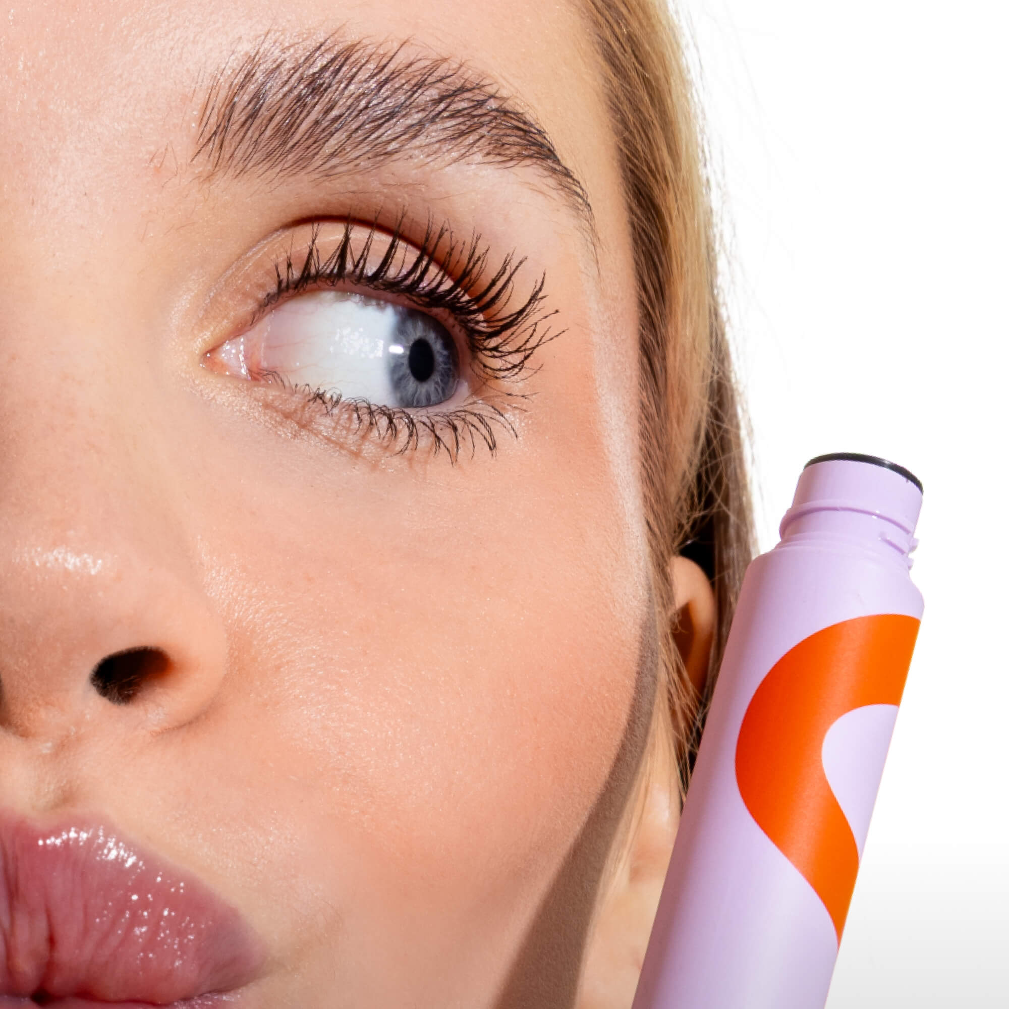A close up of a person's eyelashes after applying the Tower 28 Beauty MakeWaves™ Mascara in Drift. Lashes are visibly lifted and lengthened. [Drift]