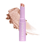 Eyeshadow with glittery texture and 'Tower 28' branding on a white background [Avalon]