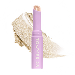Eyeshadow with glittery texture and 'Tower 28' branding on a white background [Chateau]