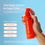 Orange spray bottle labeled 'Tower 28' held by a hand against a blue sky background [Shared]