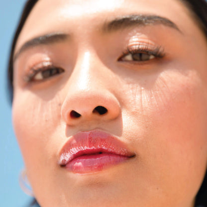 Coconut [A model wearing the Tower 28 Beauty ShineOn Lip Jelly in the shade Coconut on her lips]