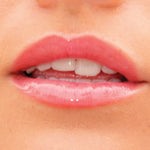 A model wearing the Tower 28 Beauty ShineOn Lip Jelly in the shade Coconut on her lips. [Coconut]