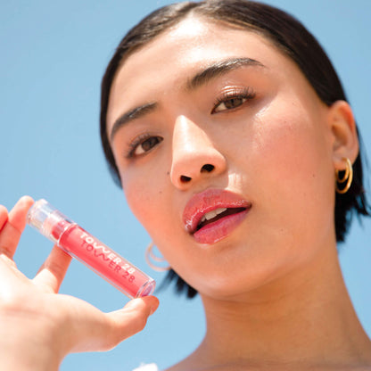 Coconut [A model wearing the Tower 28 Beauty ShineOn Lip Jelly in the shade Coconut on her lips]