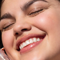 A person wearing the Tower 28 Beauty ShineOn Lip Jelly in the shade Magic on her lips. [Magic]
