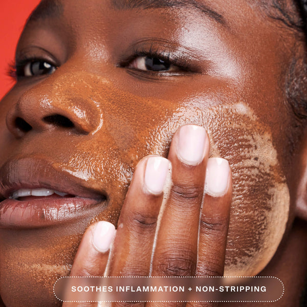 A person applying the Tower 28 SOS Gel Cleanser to their face, creating a foam and removing makeup. The text reads “Soothes inflammation + non-stripping,” highlighting the cleanser’s calming, gentle formula. [Shared]