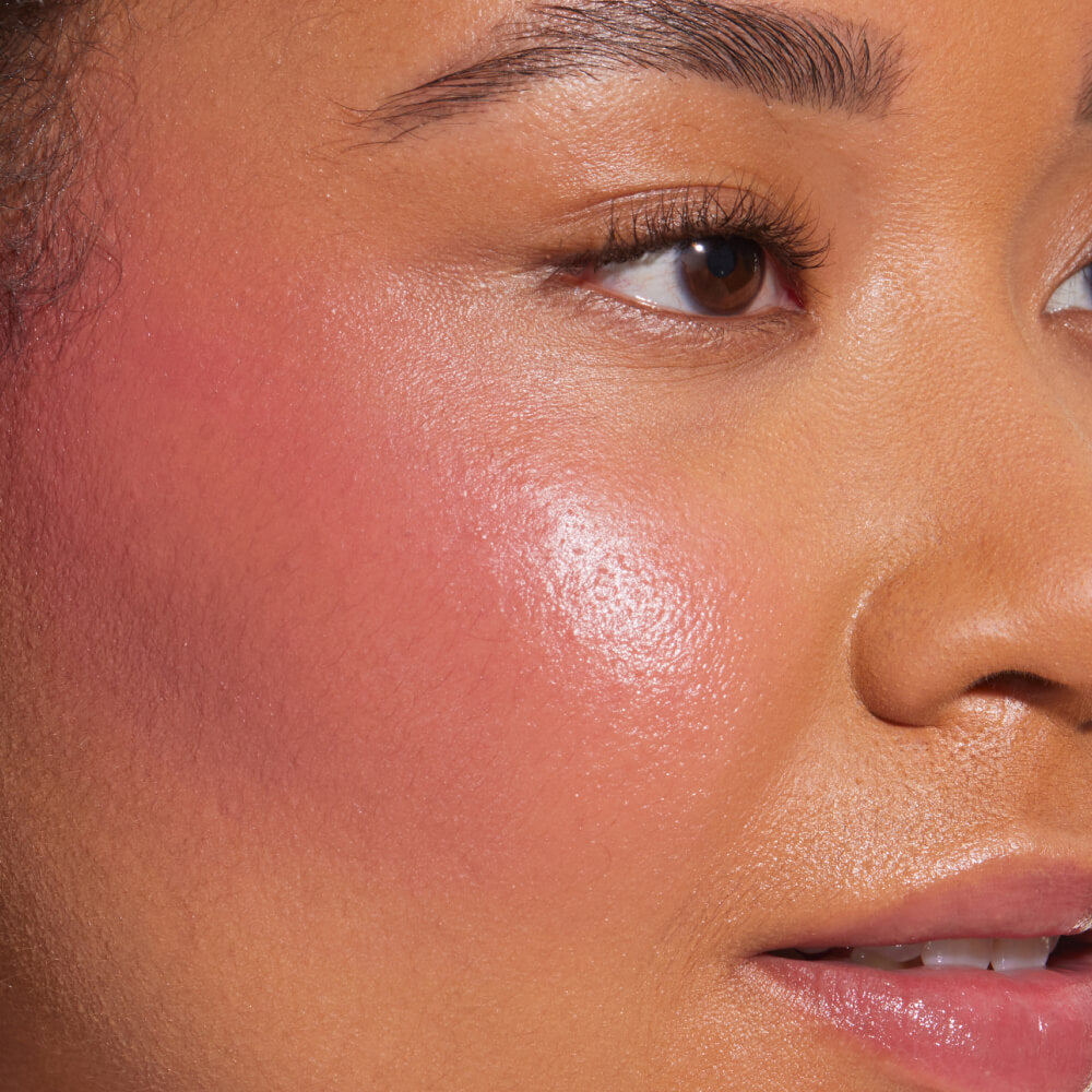 A close up of a model with Tower 28 Beauty's BeachPlease Cream Blush in After Hours on her face.