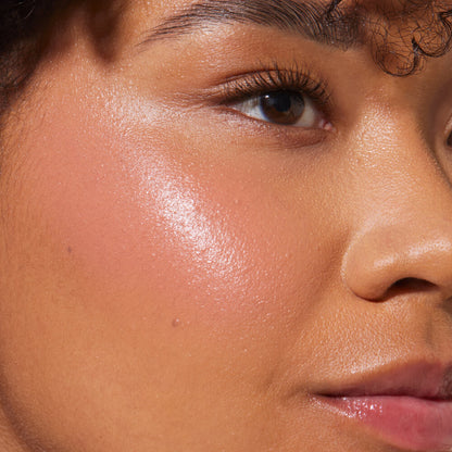 Magic Hour [A close up of a model with Tower 28 Beauty's BeachPlease Cream Blush in Magic Hour on her face.]