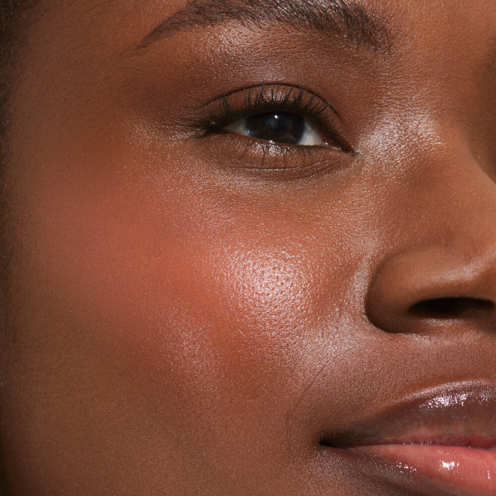 A close up of a model with Tower 28 Beauty's BeachPlease Cream Blush in Rush Hour on her face.