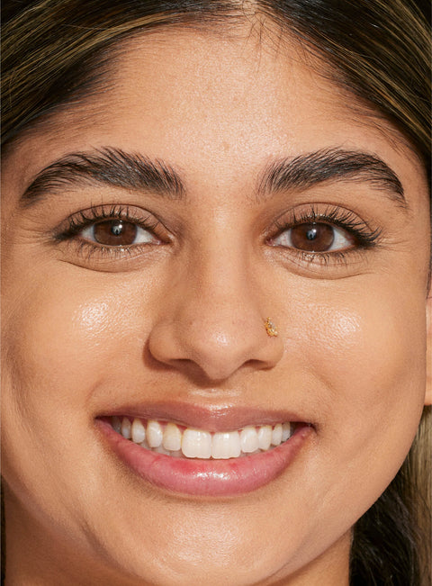 [A person's face with an evened out complexion after using Tower 28 Beauty's Swipe Serum Concealer in shade 10.]