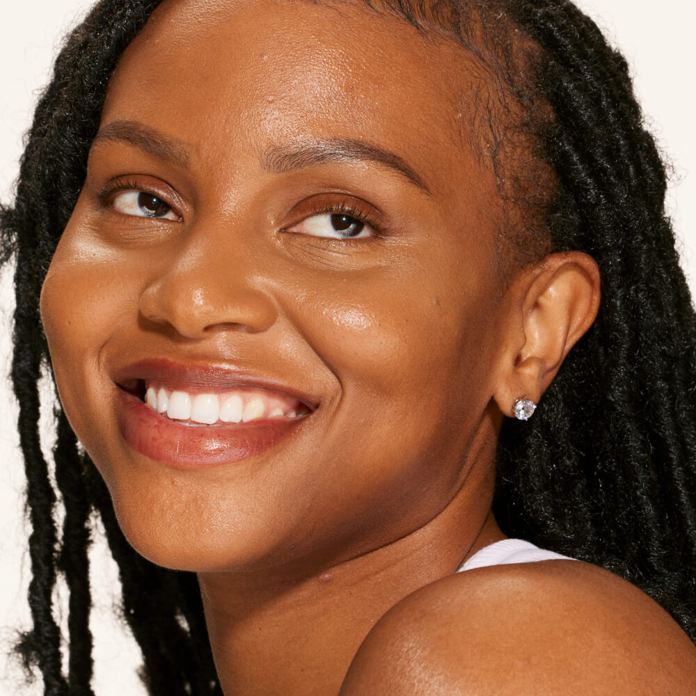 A person's face with an evened out complexion after using Tower 28 Beauty's Swipe Serum Concealer in shade 16.0 SB. [16.0 SB]