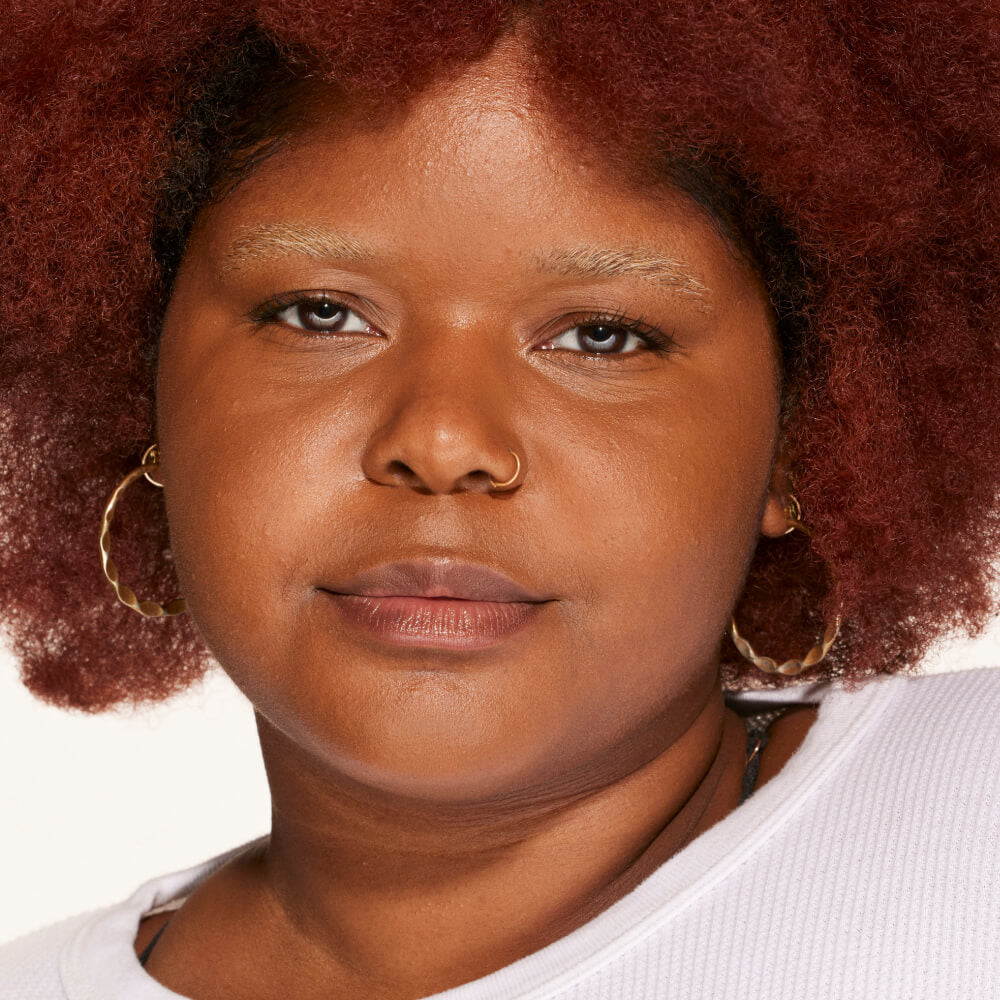 A person's face with an evened out complexion after using Tower 28 Beauty's Swipe Serum Concealer in shade 17.0 SD. [17.0 SD]