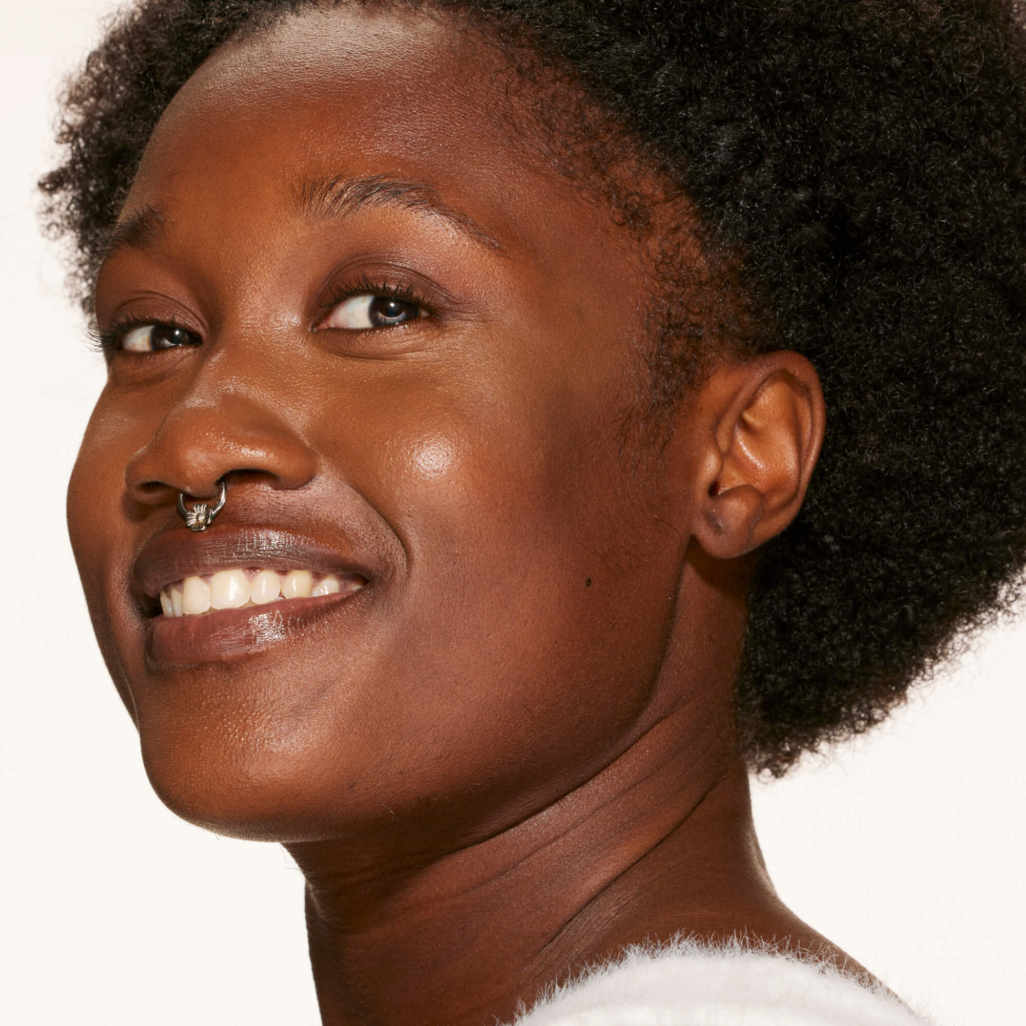 A person's face with an evened out complexion after using Tower 28 Beauty's Swipe Serum Concealer in shade 19.0 WEHO. [19.0 WEHO]