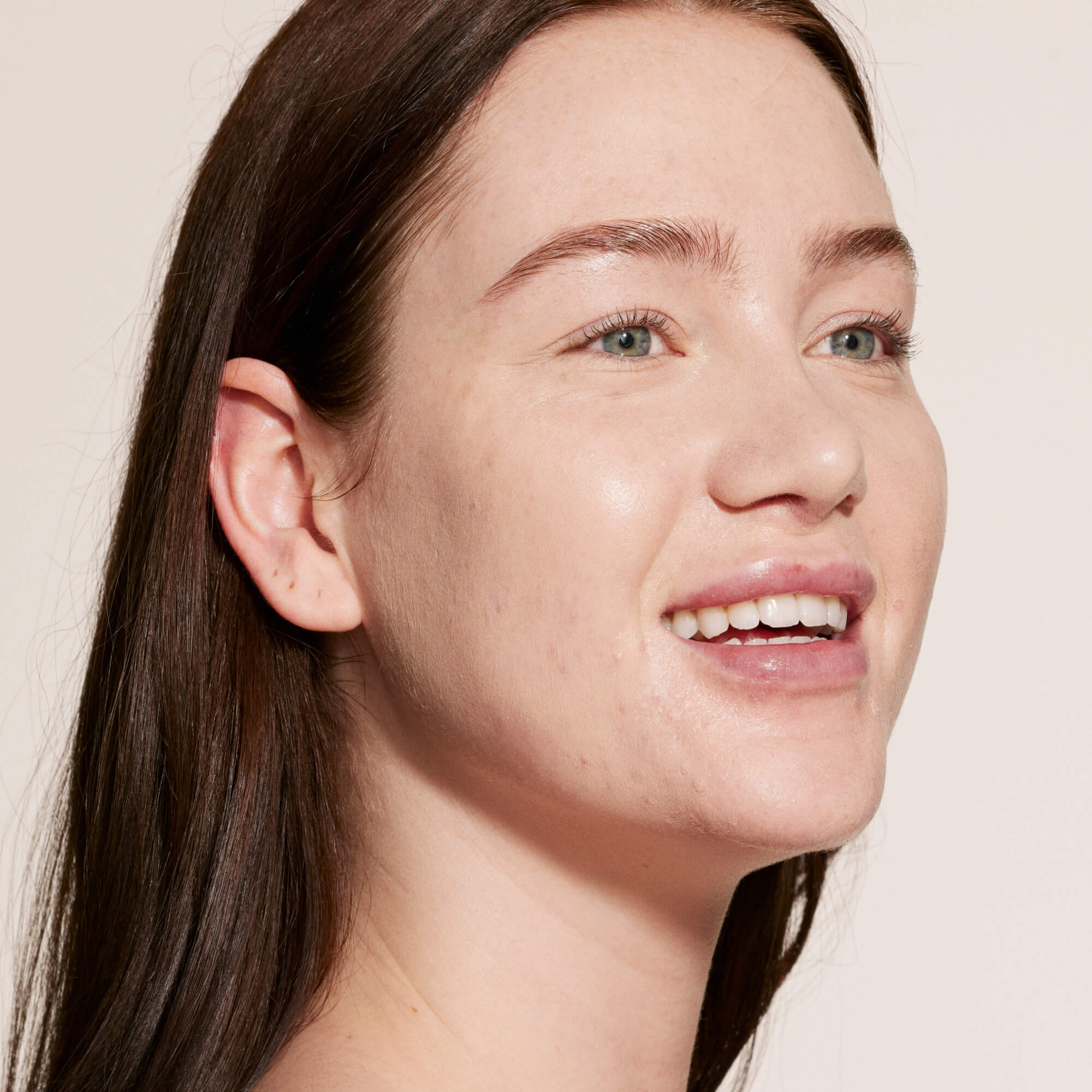 A person wearing Tower 28 Beauty's Swipe Serum Concealer in shade 2.0 BU, shown with a smooth, radiant finish and even skin tone. [2.0 BU]