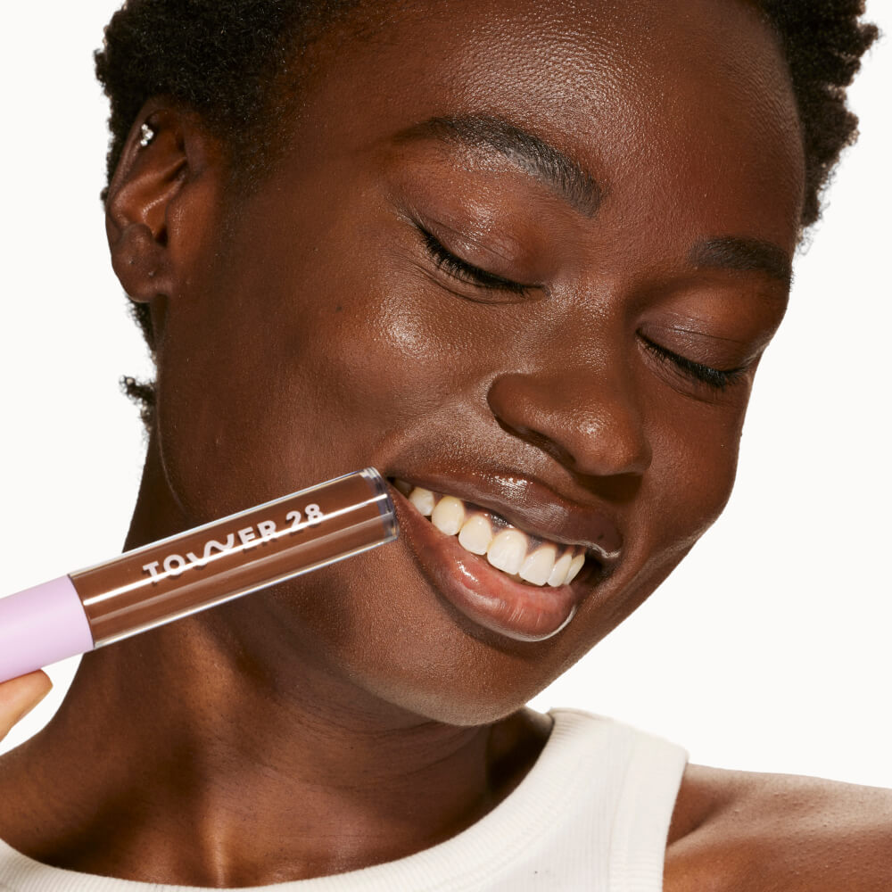 A person's face with an evened out complexion after using Tower 28 Beauty's Swipe Serum Concealer in shade 20.0 WLA. [20.0 WLA]