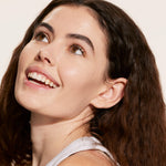 A person wearing Tower 28 Beauty's Swipe Serum Concealer in shade 3.0 CC, shown with a bright, natural finish and even coverage across the skin. [3.0 CC]