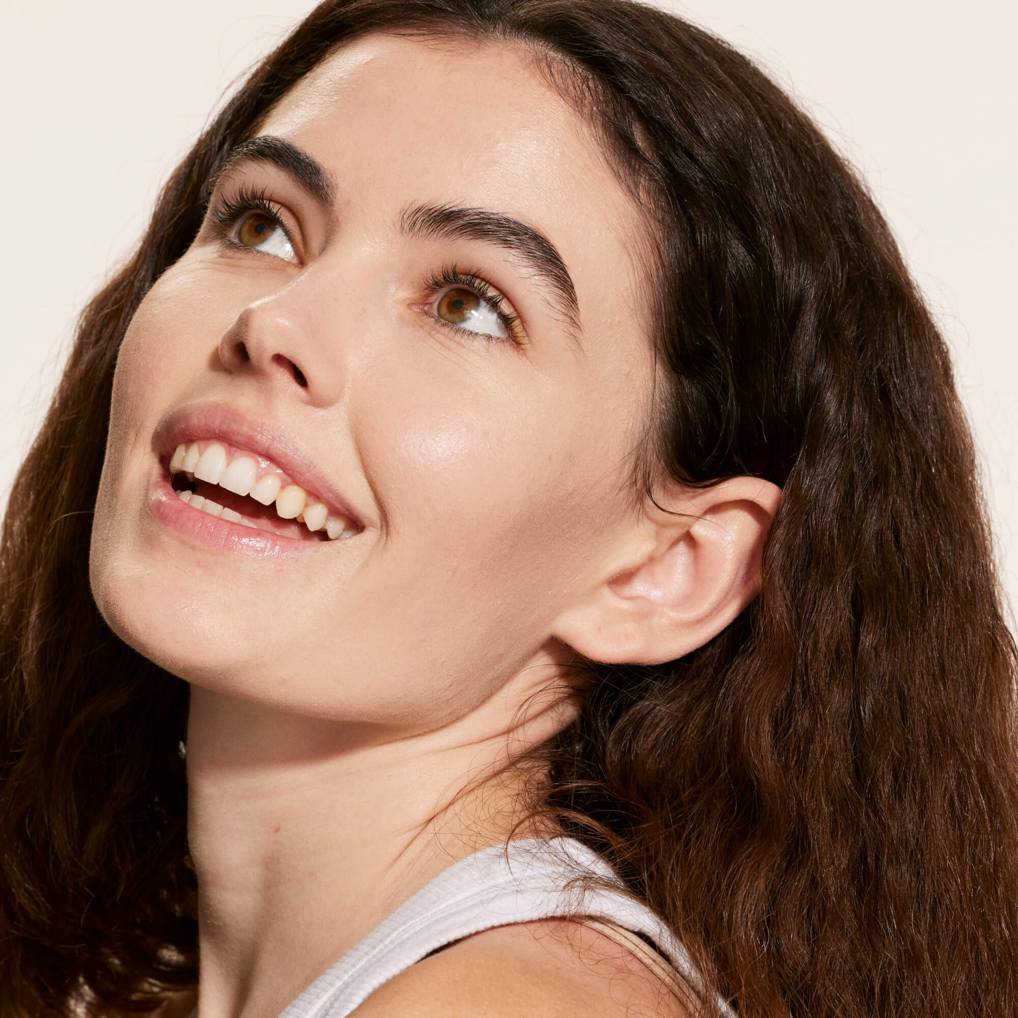 A person wearing Tower 28 Beauty's Swipe Serum Concealer in shade 3.0 CC, shown with a bright, natural finish and even coverage across the skin. [3.0 CC]