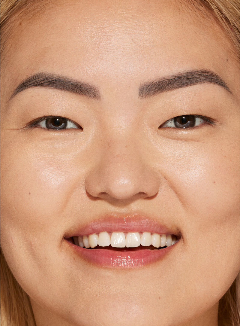 [A person's face with an evened out complexion after using Tower 28 Beauty's Swipe Serum Concealer in shade 6.0]