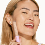 A person’s face after using Tower 28 Beauty's Swipe Serum Concealer in shade 6.0 IE to visibly reduce redness, blur texture, and even out skin tone. [6.0 IE]