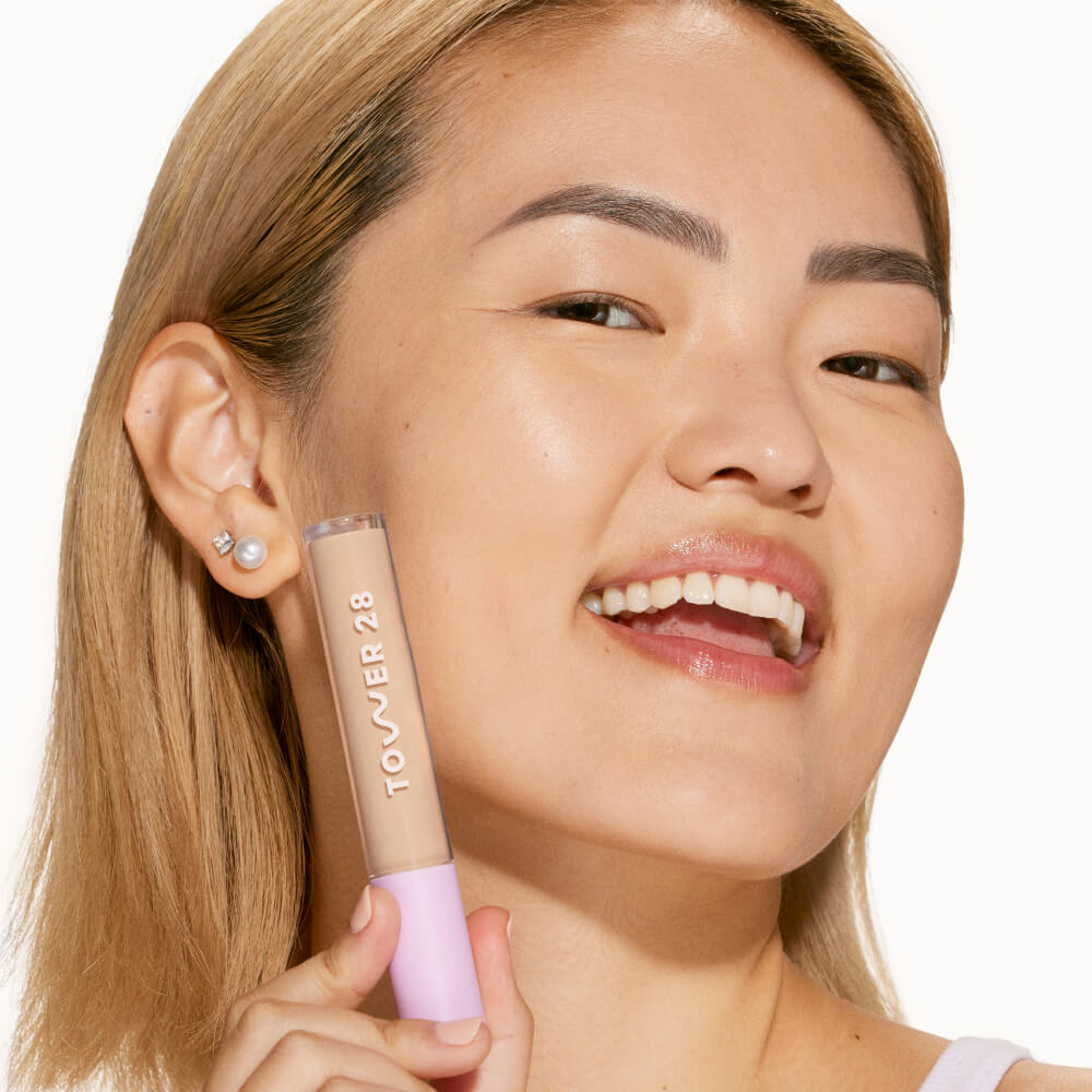 A person’s face after using Tower 28 Beauty's Swipe Serum Concealer in shade 6.0 IE to visibly reduce redness, blur texture, and even out skin tone. [6.0 IE]