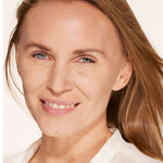 A person wearing Tower 28 Beauty's Swipe Serum Concealer in shade 6.0 IE, shown with a brightened, even complexion and natural finish. [6.0 IE]