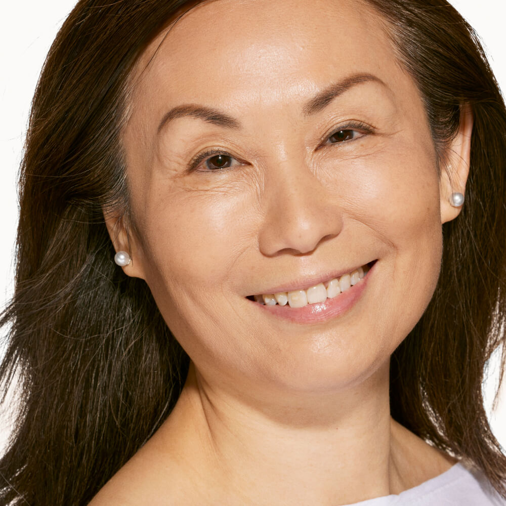 A person wearing Tower 28 Beauty’s Swipe Serum Concealer in shade 7.0 KTOWN, shown with an even, natural complexion and smooth finish. [7.0 KTOWN]