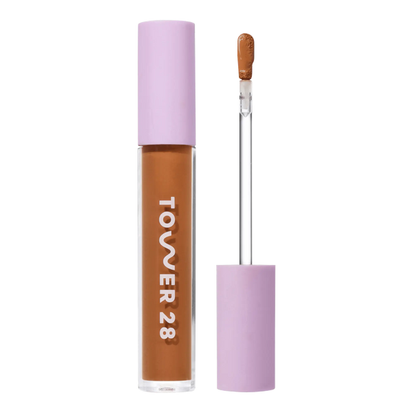Tower 28 Beauty Swipe Serum Concealer in the shade 15.0 SAMO, shown with the tube standing upright next to the open applicator wand to reveal the product. [15.0 SAMO]